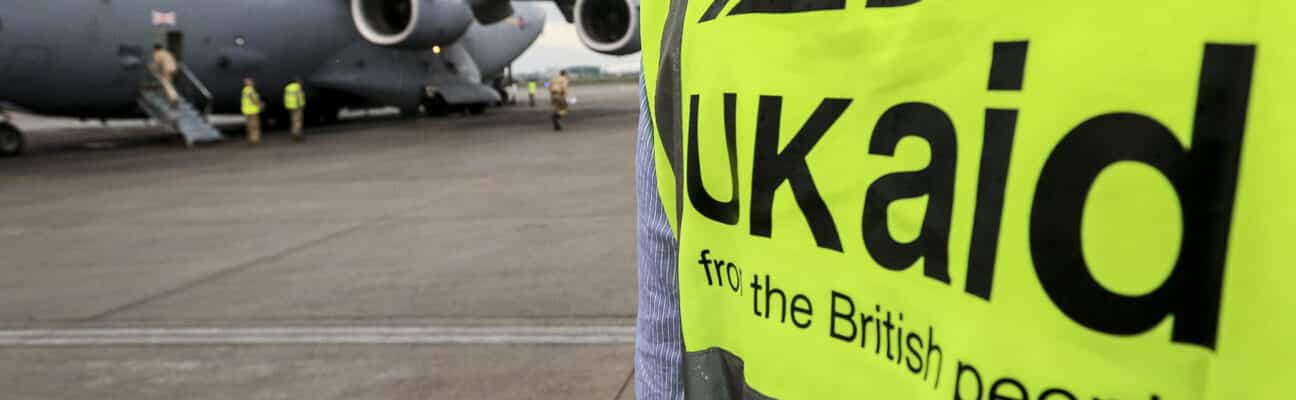 UK aid worker outside a plane