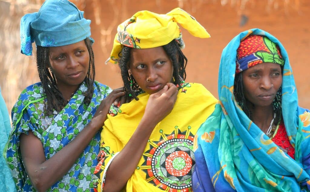 Three women stand together