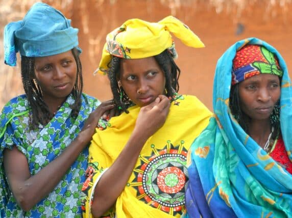 Three women stand together