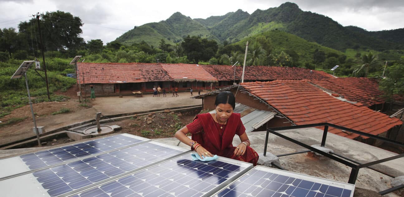 Meenakshi Dewan installing solar panels on a house