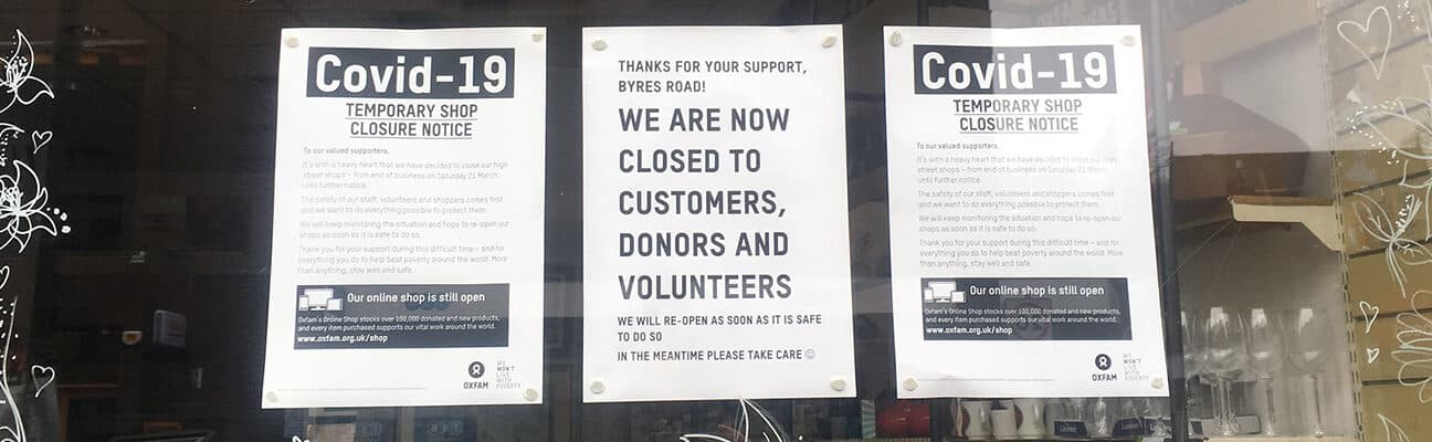 Sign in shop window showing closure due to covid