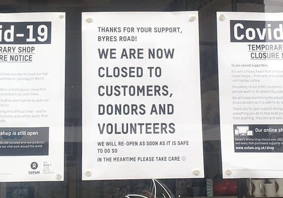 Sign in shop window showing closure due to covid