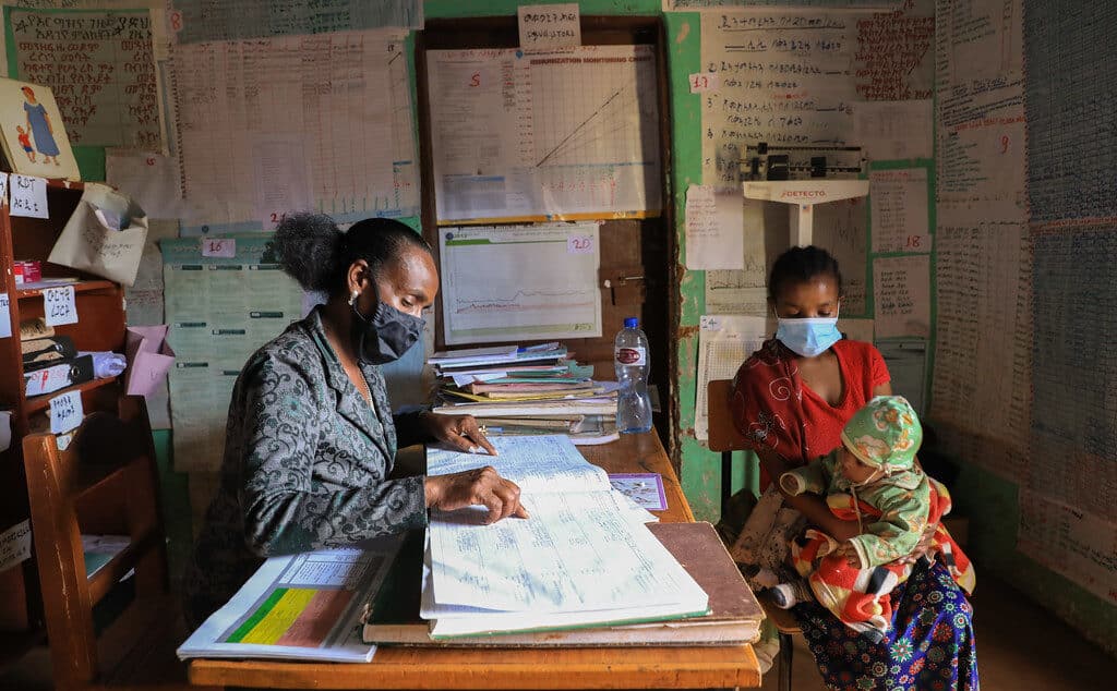 Elfinesh Tefera, a health extension worker supporting Birtukan Fetene, a mother of four with her two months old son, Amanuel Wondemu