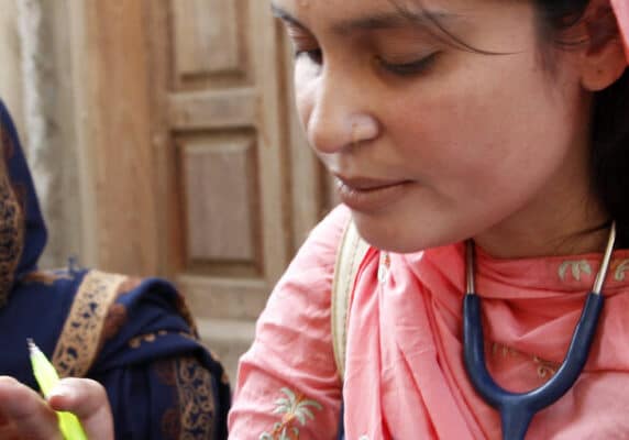 A female doctor with the International Medical Corps examines a woman patient at a mobile health clinic in Pakistan