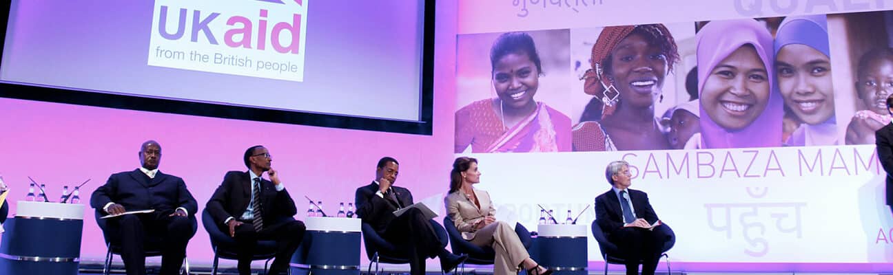 International Development Secretary Andrew Mitchell (second from right) looks on as Prime Minister David Cameron addresses the audience at the London Summit on Family Planning in 2012