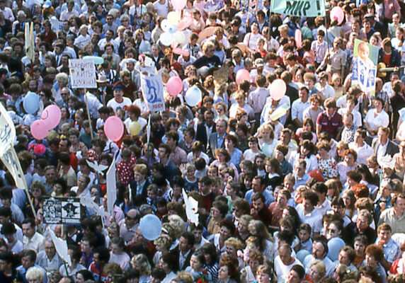 A crowd of people protesting for peace