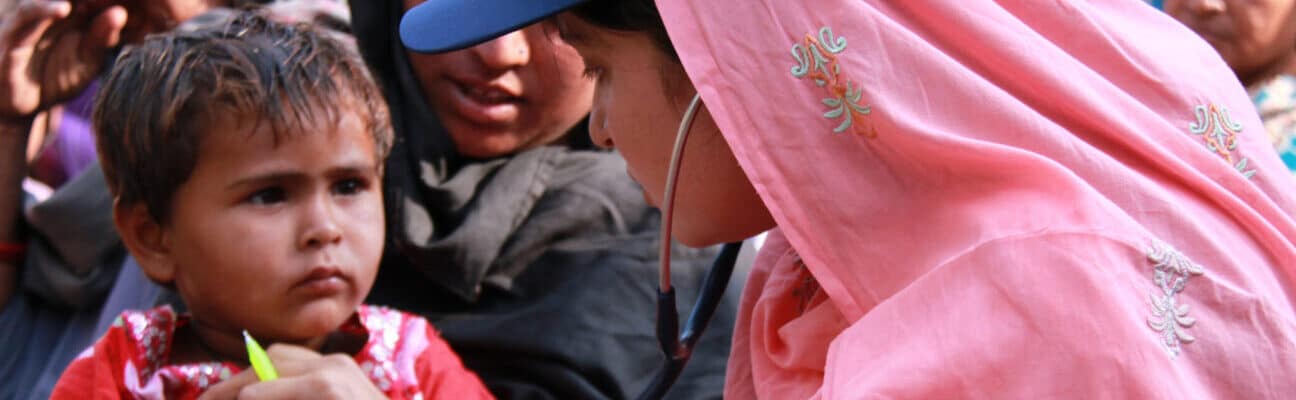 A doctor examines a young boy at a mobile health clinic in Pakistan