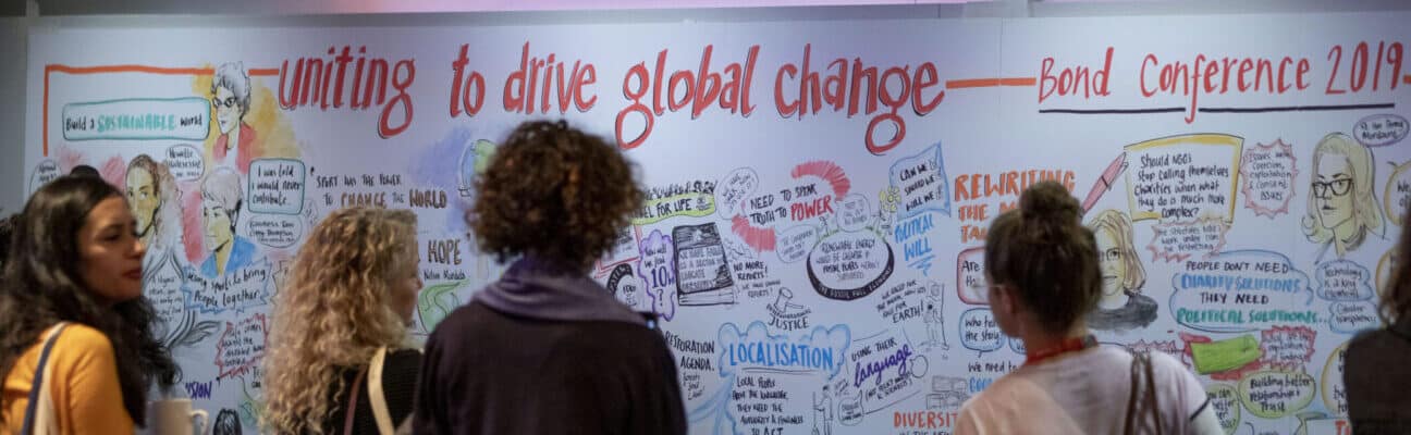 People reading board at BOND Conference 2019