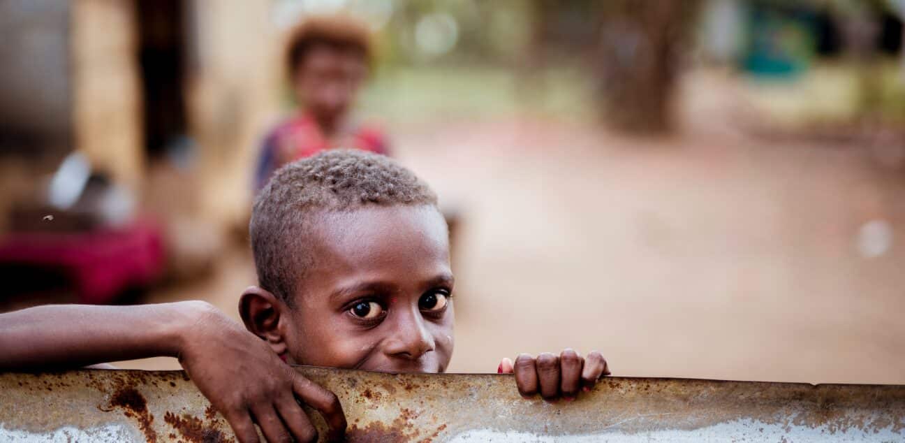 A boy looking over a metal sheet