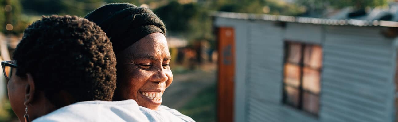 Two activists embrace in KwaMashu, an informal settlement north of Durban, South Africa. Christian Aid’s partner, Church Land Programme, works closely with the shackdweller movement (Abahlali baseMjondolo) so that people in KwaMashu can live without fear