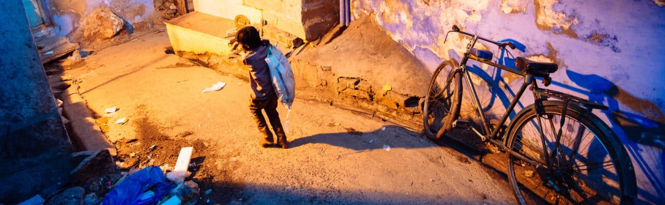 Child carrying sack in Jodphur, India