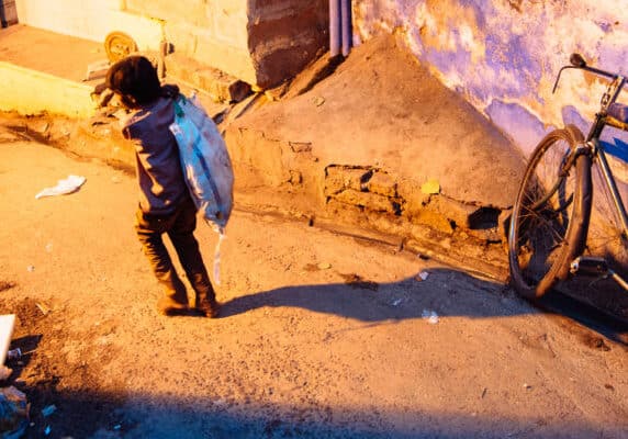 Child carrying sack in Jodphur, India