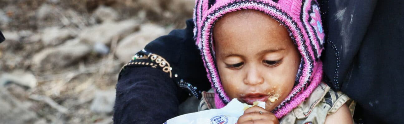 Child in Yemen eating food