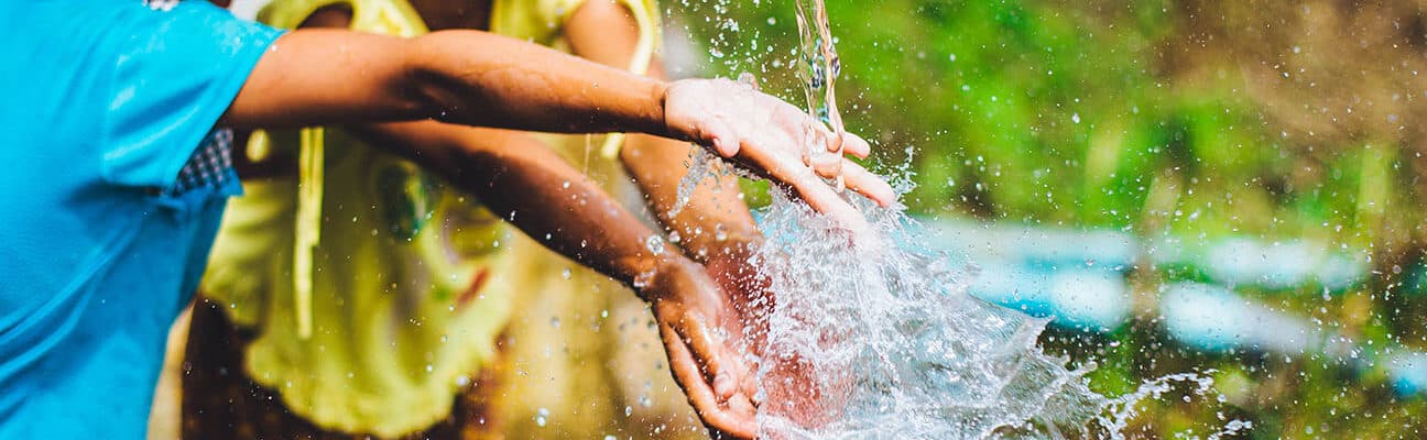 Two children playing with water in Chiang Mai, Thailand