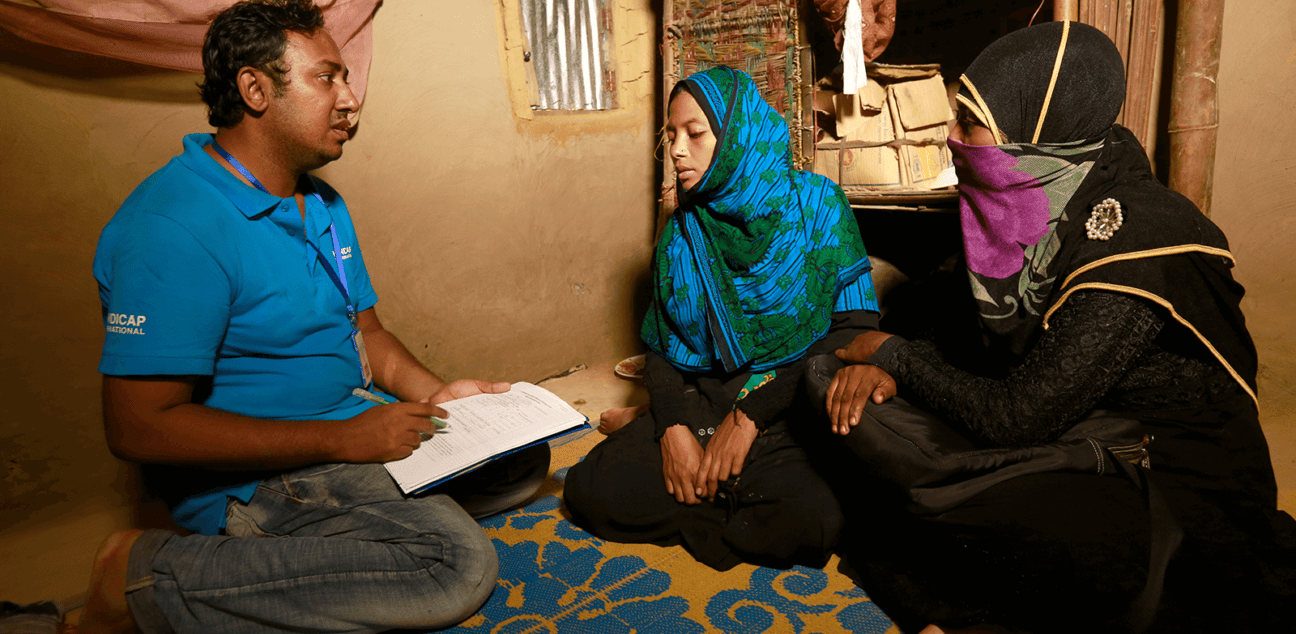 Man conducting an assessment with two women