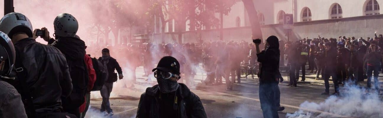 A protest with teargas and someone filming