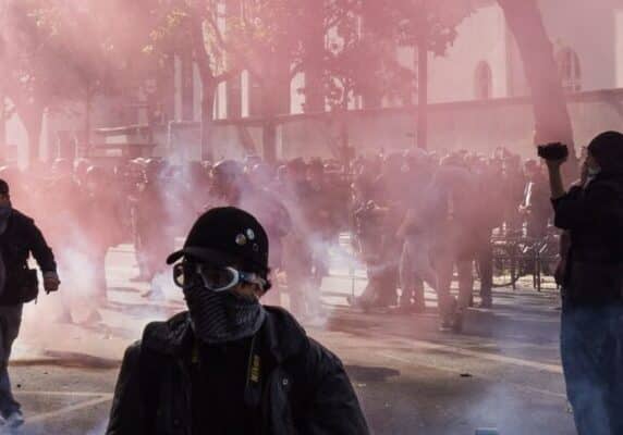 A protest with teargas and someone filming