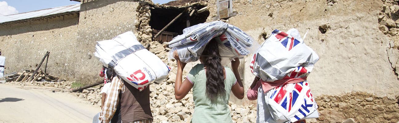 Women carrying UK aid bags in Nepal