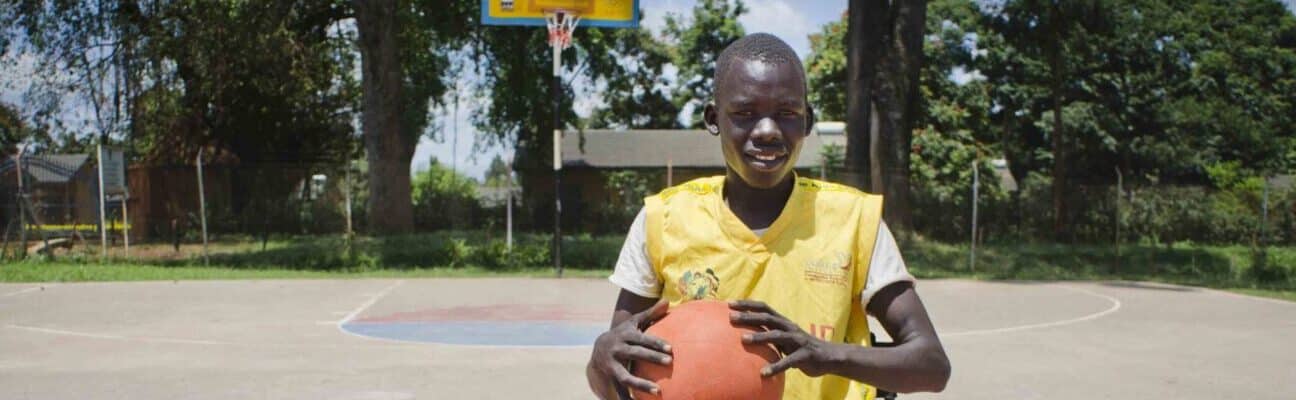 Denis preparing to play wheelchair basket ball in Uganda