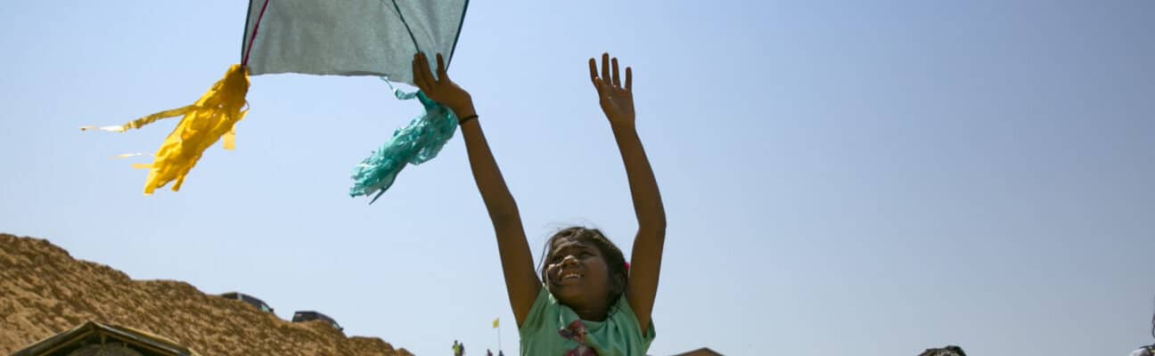 Girl playing with a kite in Rohingya refugee camp