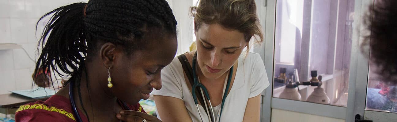 Two NHS healthcare professionals examine a chart