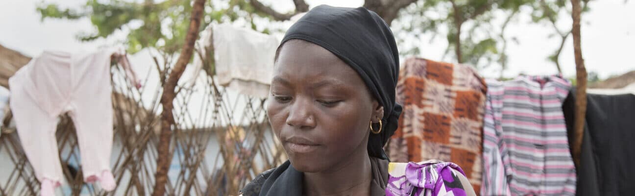 Hawa, refugee in a camp in Cameroon, with a clipboard
