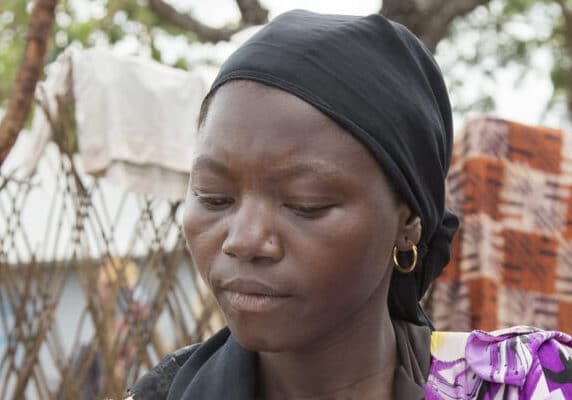 Hawa, refugee in a camp in Cameroon, with a clipboard
