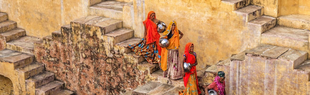 Woman carry water on steps in Jaipur- India