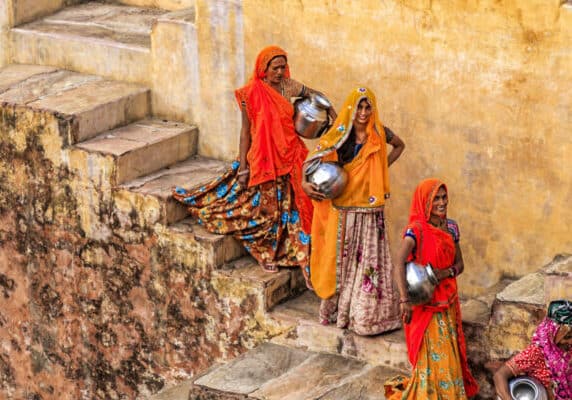 Woman carry water on steps in Jaipur- India