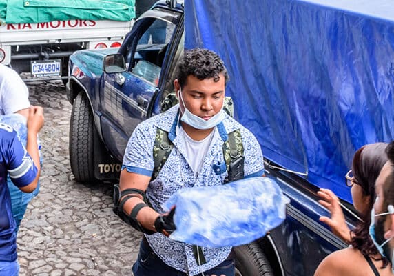 Volunteers load supplies outside town hall in Antigua, Guatemala to take to area affected by eruption of Fuego (fire) volcano