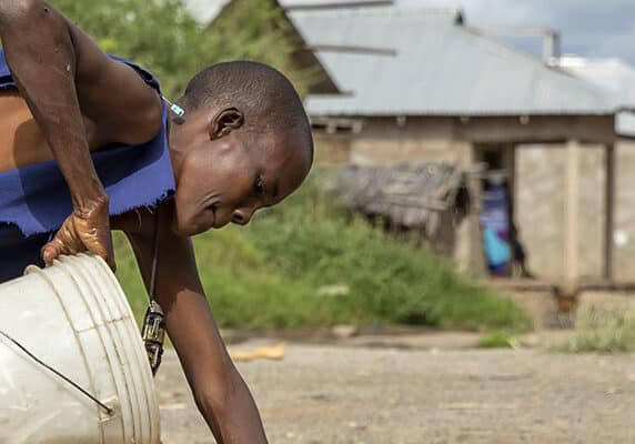 A women collects water in Tanzania