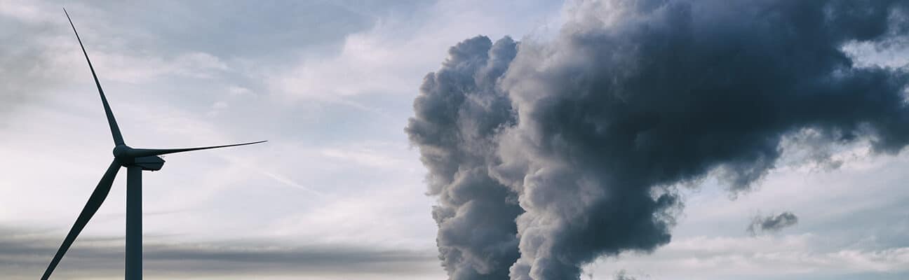 Wind tubine next to factory pollution