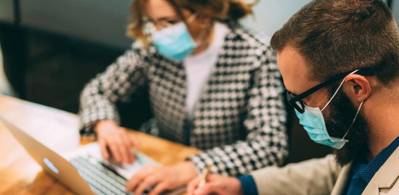 Man and woman work on a laptop