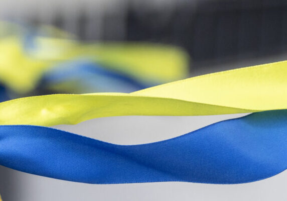Ribbons in the colors of the national flag of Ukraine are tied to the handrail.