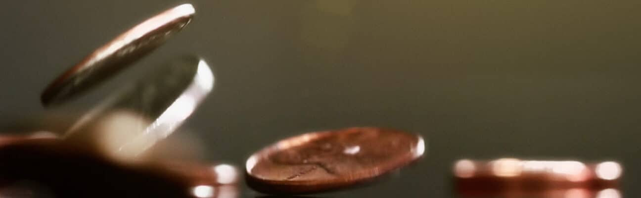 Mixed American coins falling, showing motion blur