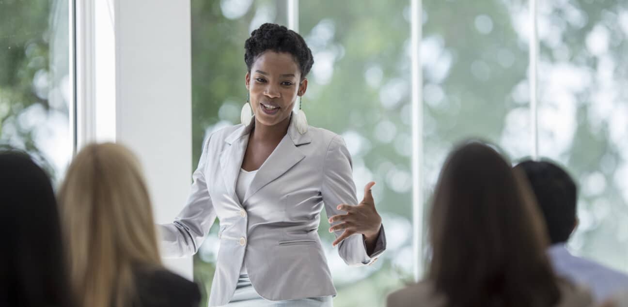 A woman presenting to colleagues