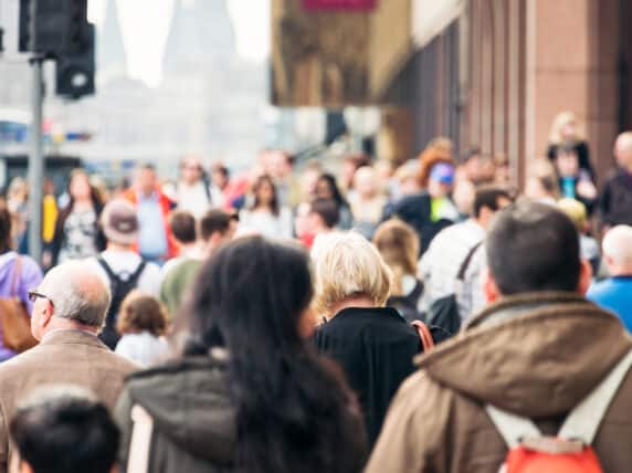 People walk in a busy street