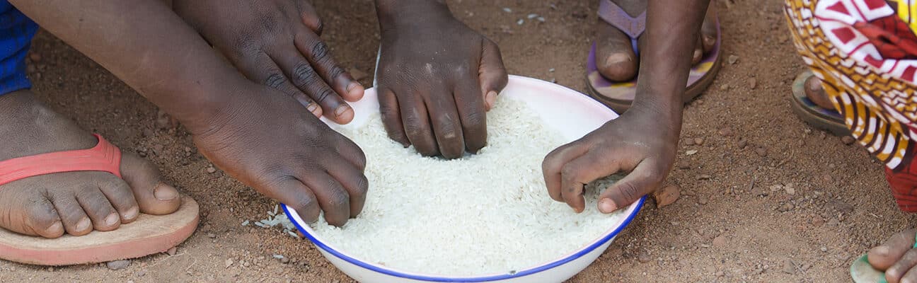 Young boys and girls in Bamako, Mali eating outside