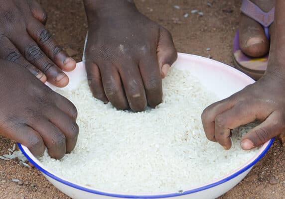 Young boys and girls in Bamako, Mali eating outside