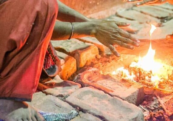 Children crouch over a small fire in Kolakata, India