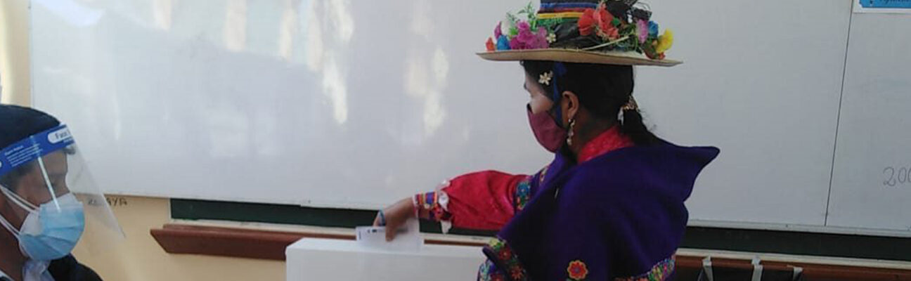 An Indigenous voter casts her ballot during Peru's 2021 elections. © National Office of Electoral Processes