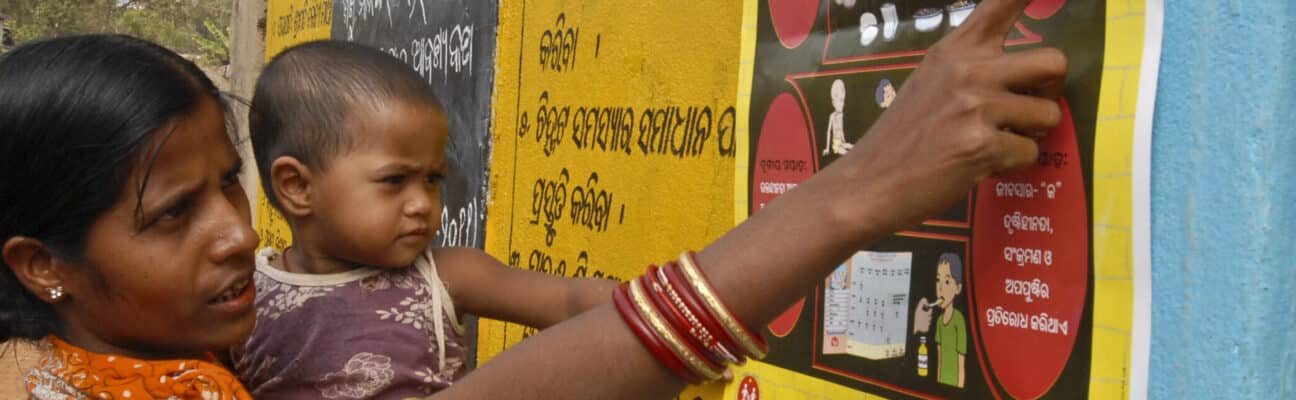 Woman reads a poster with a child