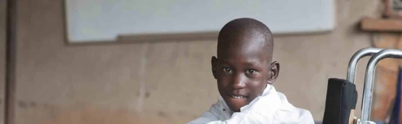 Young boy sits in a wheelchair