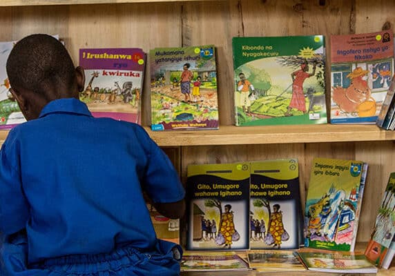 A student chooses a book from a cabinet at the Groupe Scolair Ruhanga school in Burera District of Rwanda.