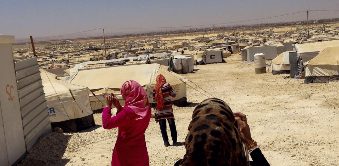 Teenage girls taking photos for an assignment in Zaatari refugee camp