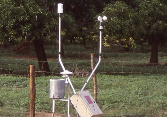 Satellite-linked rain gauge and weather station in a mango orchard in Burkina Faso, West Africa