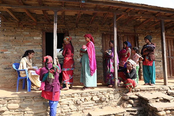 Mothers queue at health clinic for immunisation