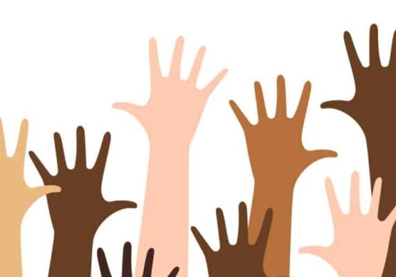 Diverse raised hands isolated on a white background.