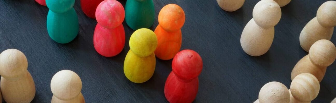 Equality rights and diversity concept. Color figurines and wooden ones.