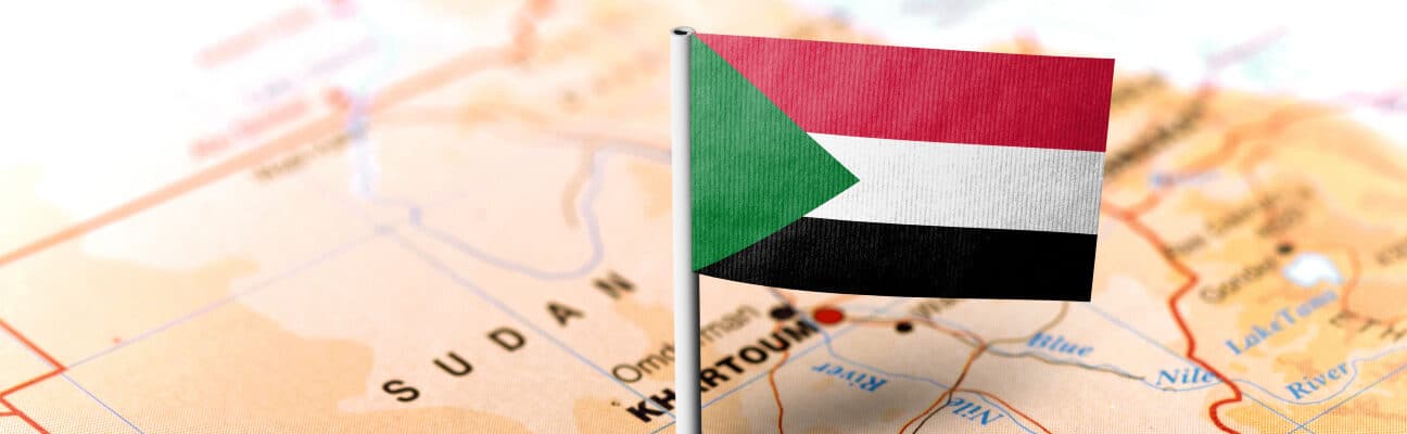 The flag of Sudan pinned on the map. Horizontal orientation.
